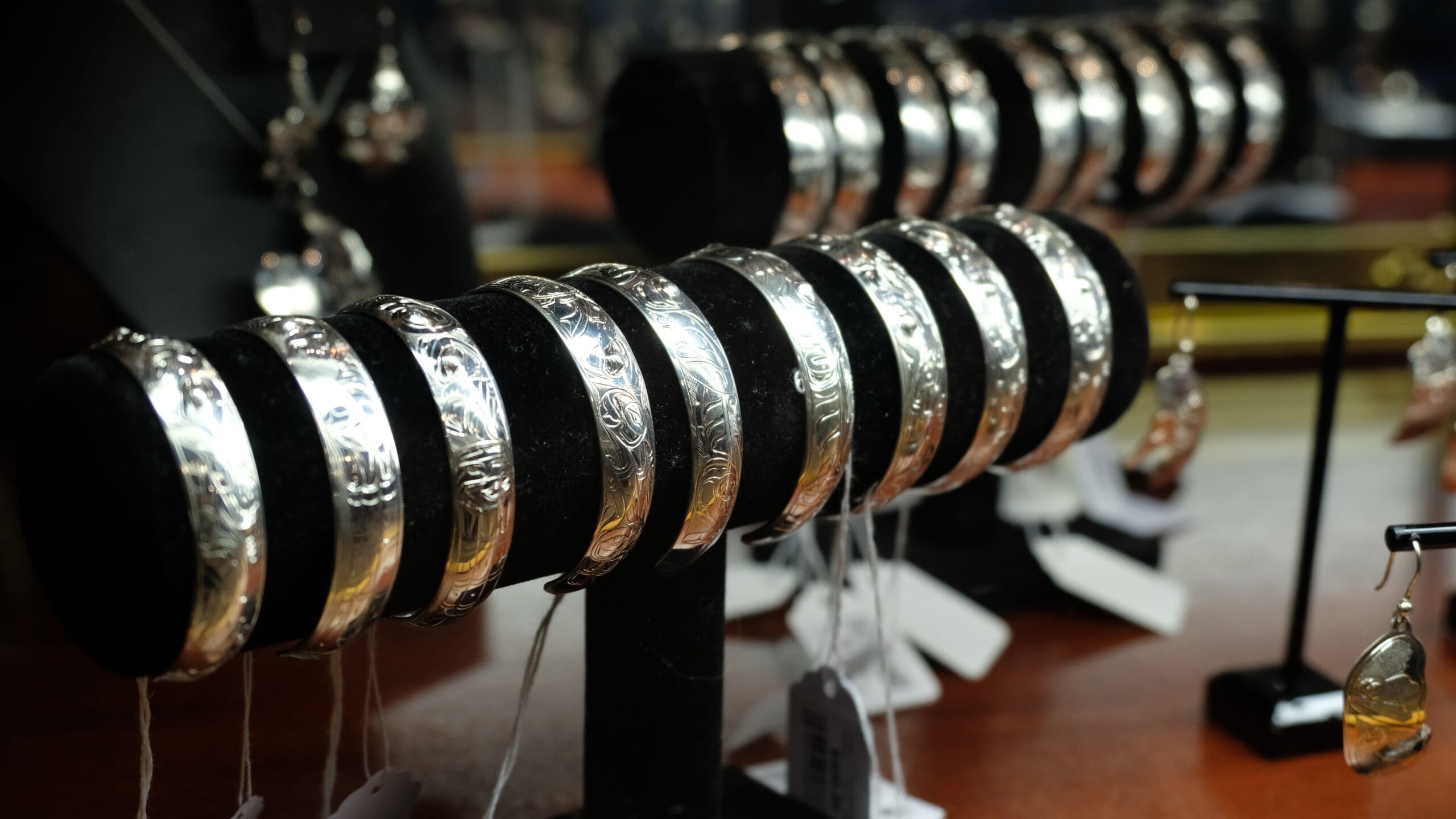 Handcrafted silver cuff bracelets displayed for sale inside Aan Hít retail shop in Juneau Alaska
